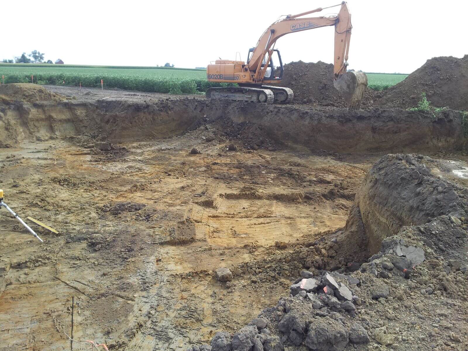 A large excavator is digging in the dirt.