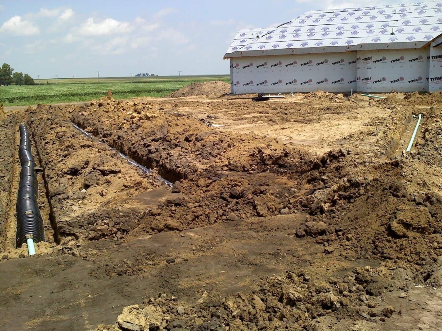 A white building sitting in the middle of a field.